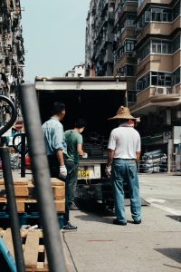 Three men unloading a truck