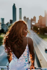 African-American woman in a gown, with the highway in the background.