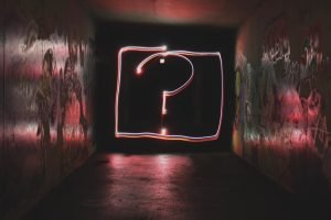Glowing question mark on a wall - ask the right questions when decluttering before packing