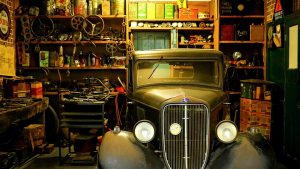 A vintage car in a garage.