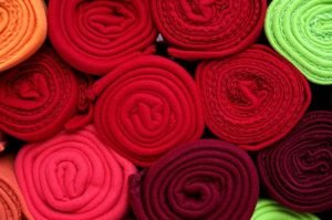 Rolled red fabrics and piled up