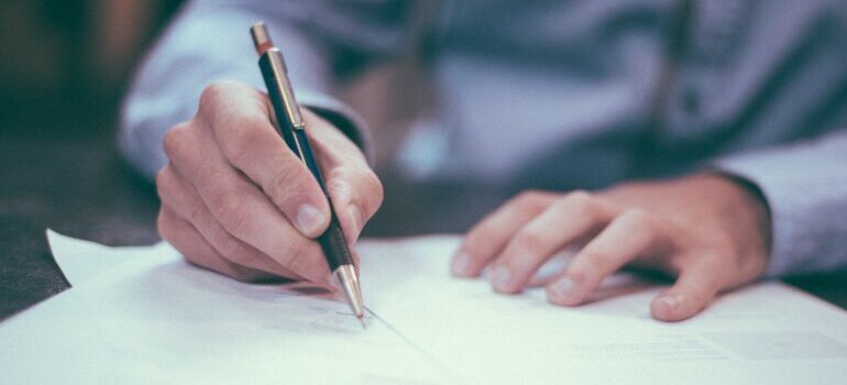 person signing in a contract