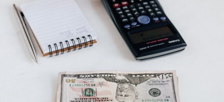money, calculator, notebook on the table