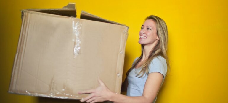 woman holding a moving box