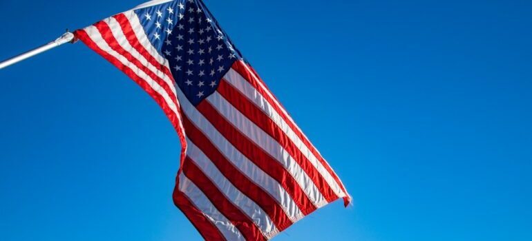 Flag of the United States of America under the blue sky.