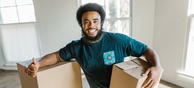 man holding a box and smiling
