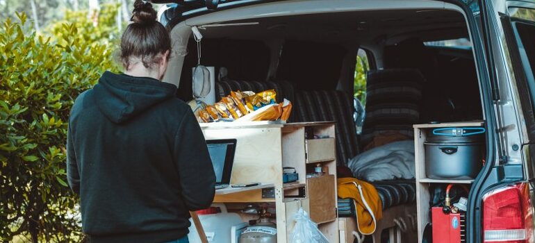 person filling a moving van with stuff