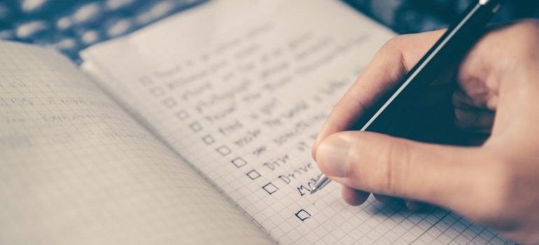 a person writing a checklist