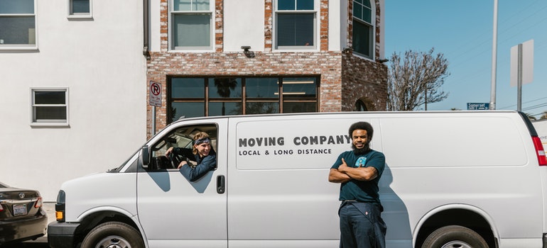 two guys and a white moving van
