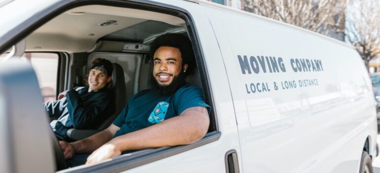 Two movers in a moving truck.