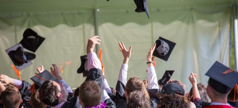 Students throwing caps after graduating in some of the best public schools in Florida