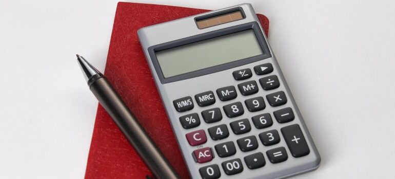 calculator, a pen, and a notebook - a couple of things you will need to compare interstate moving companies in Arkansas