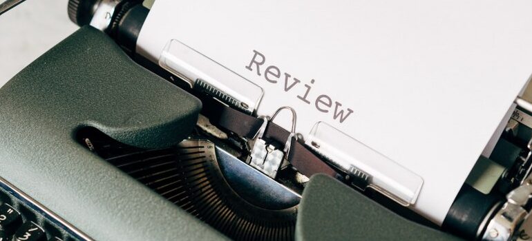 a typewriter with a sheet of paper with "review" written on it