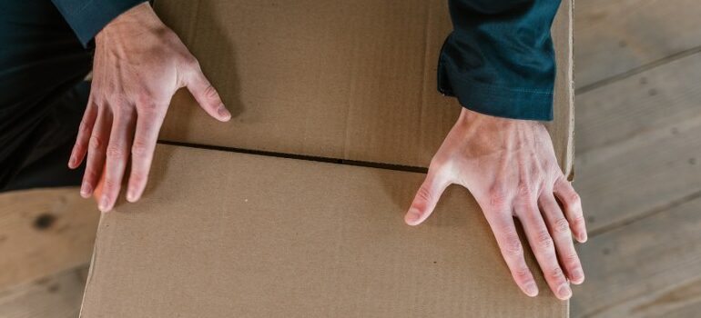 a mover handling a cardboard box