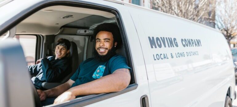 Two movers in a moving van.