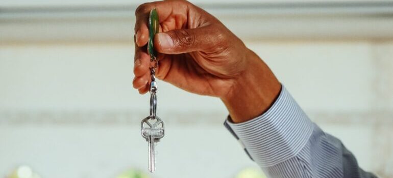 a person holding a key in his hand