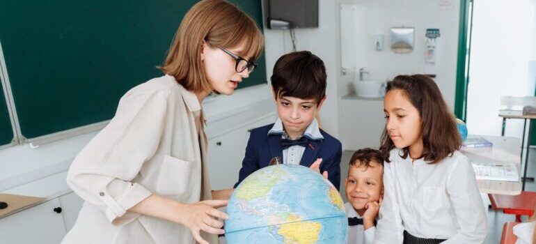 Teacher and students discussing about geography