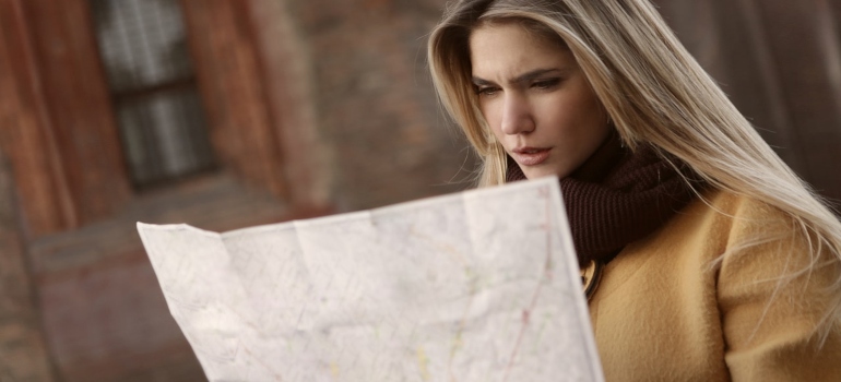 The girl looking at the map.