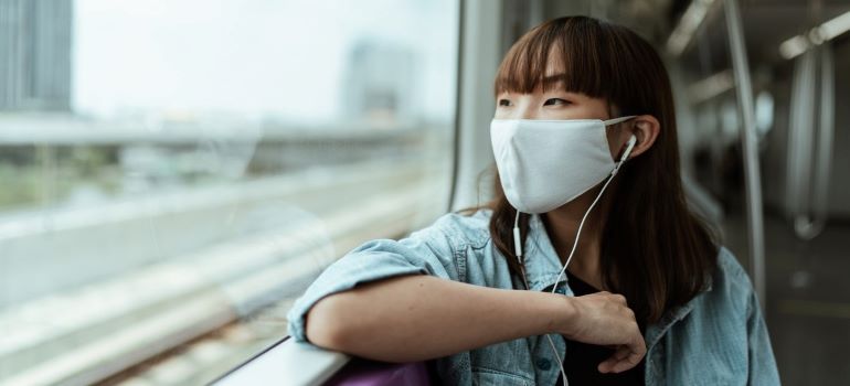a woman with a mask riding in a subway as the pandemic gives rise to how many times does the average family move