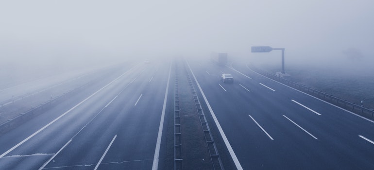 An empty road covered with fog.