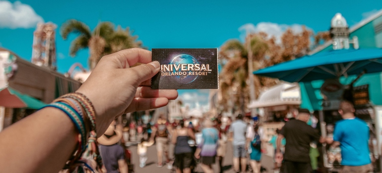 a person holding universal studios card 