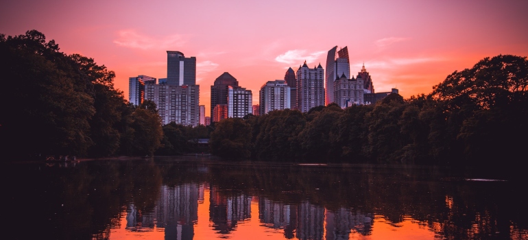 a panoramic view of skyscrapers in Atlanta, with the sunset behind them
