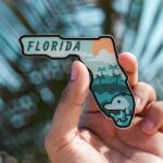Holding a miniature state and thinking about the best cities to live in Florida