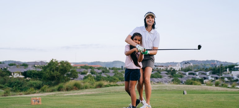 Mother and Daughter Playing Golf.