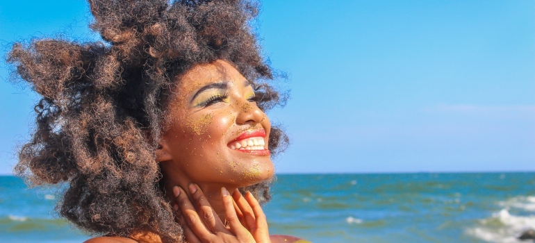 a woman smiling on a beach