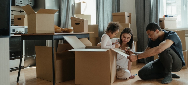 a family preparing to move and playing with cardboard boxes