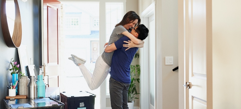 a young couple moving in an apartment 