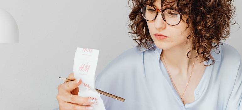 Woman looking at receipt