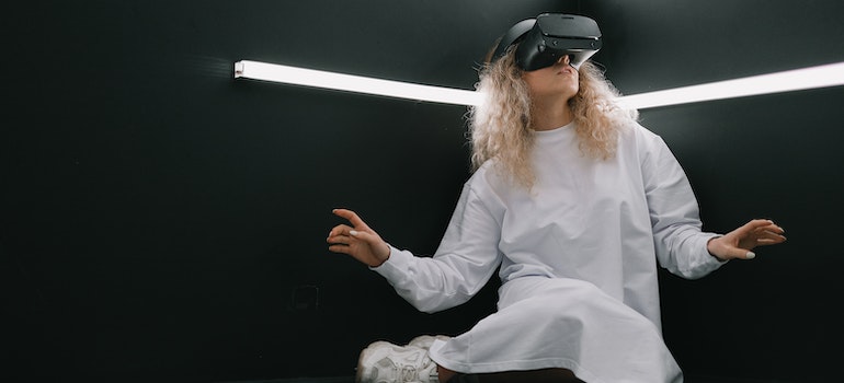 Woman in VR Glasses in Black Room.