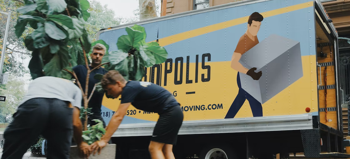 A moving truck and three moving workers