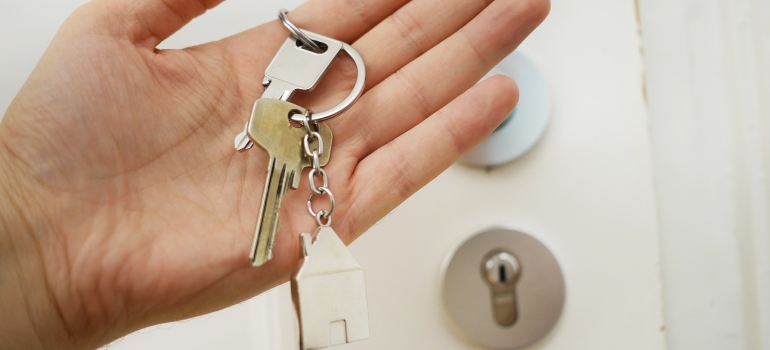 A woman holding the key of her new house