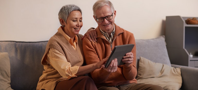 A couple looking at a tablet.