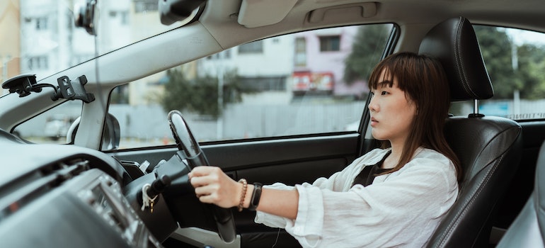 Serious Asian women driving a car. 