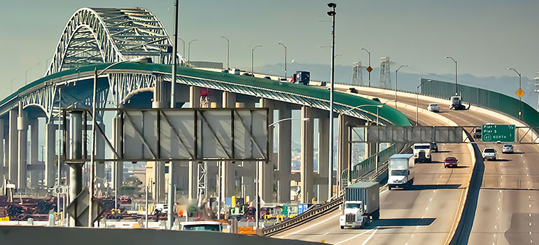 trucks of best cross country movers Long Beach crossing the bridge