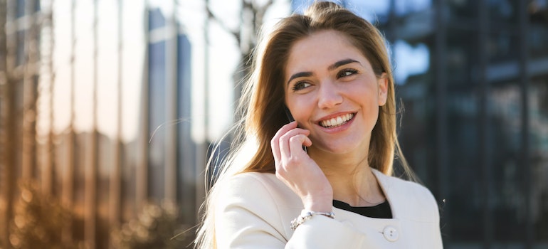 A woman smiling and talking on the phone