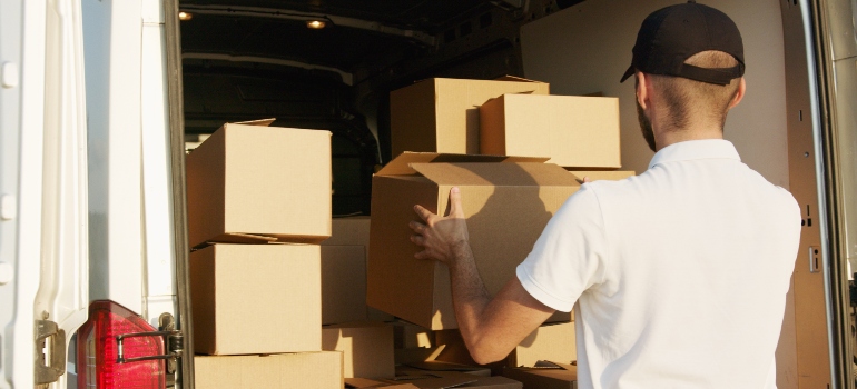 mover putting boxes in the van as many best cross country movers Roswell offer packing services